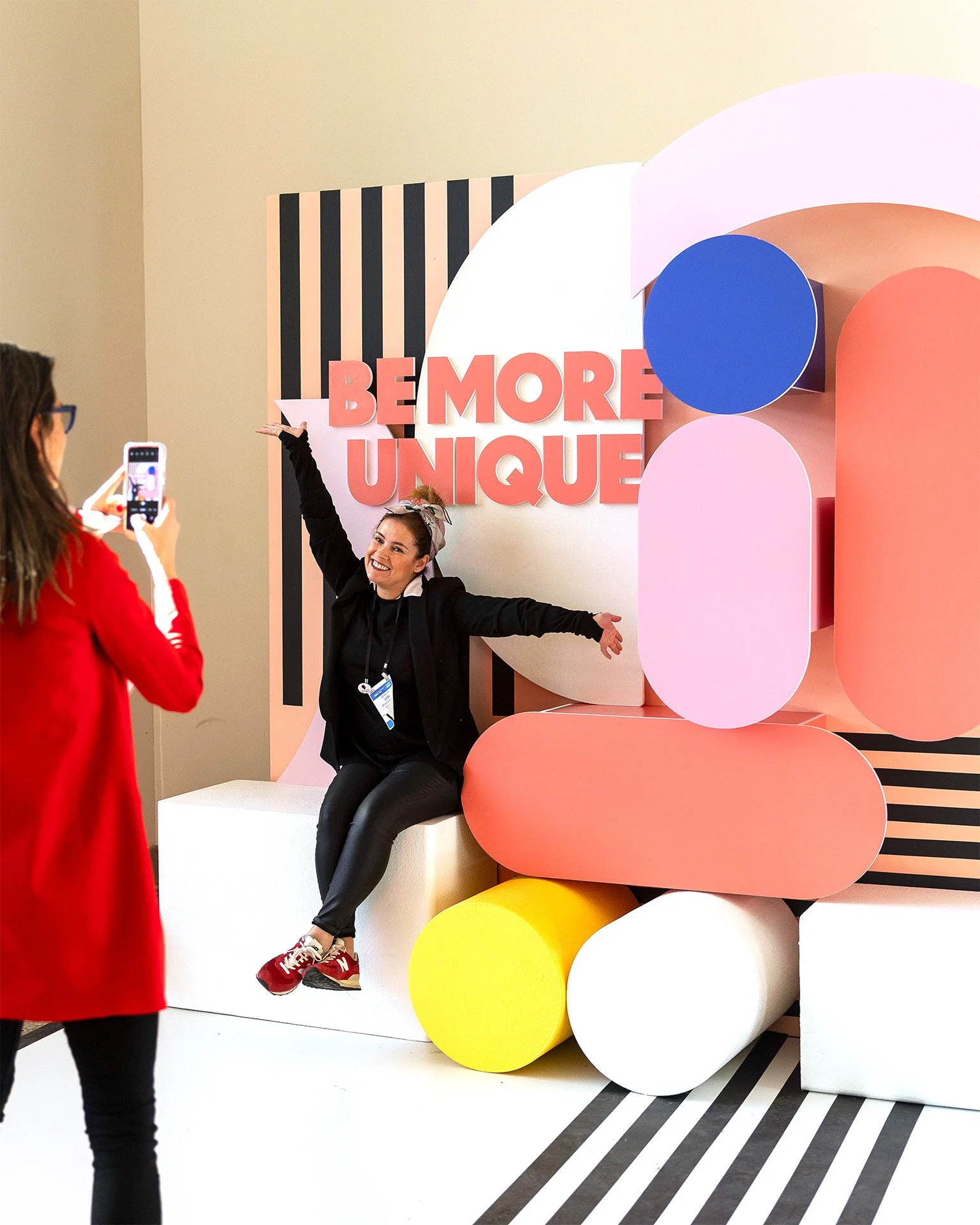 Guest posing at a colorful branded photo moment